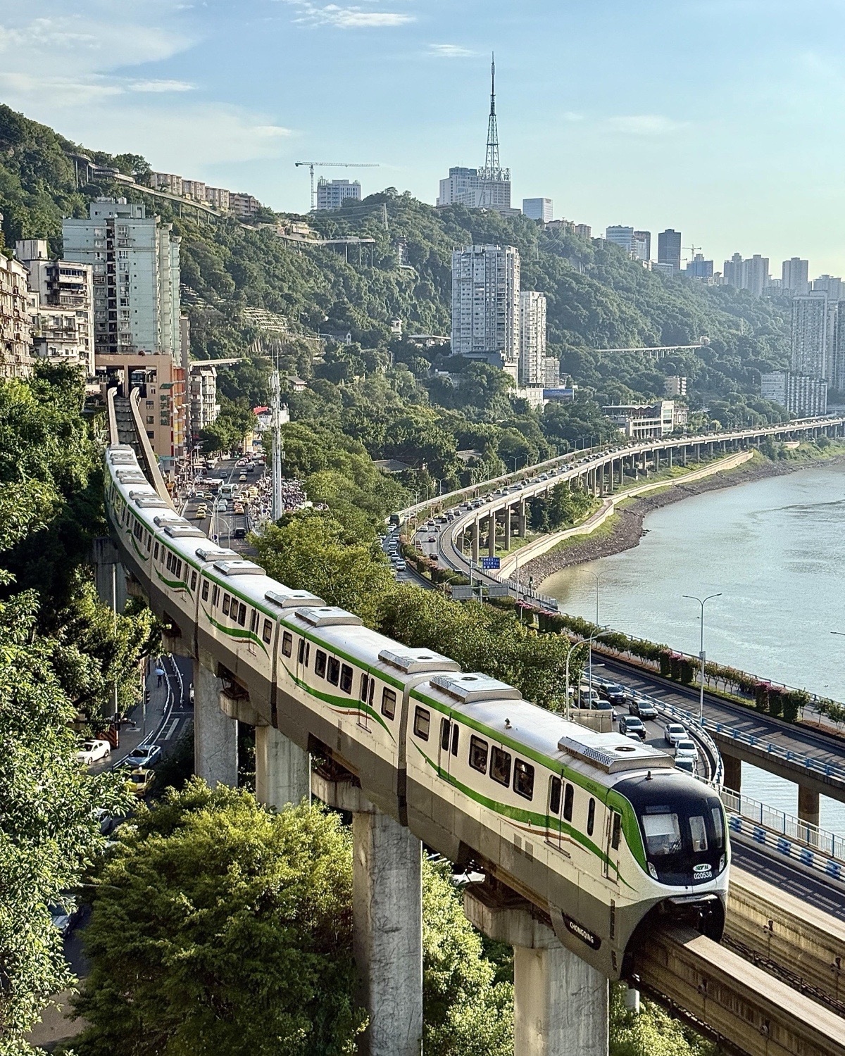 A Chongqing monorail moves through the city’s steep, layered buildings
